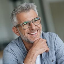 gray-haired man smiling with dentures in Dallas 