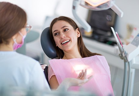 Female dental patient talking to female dentist 