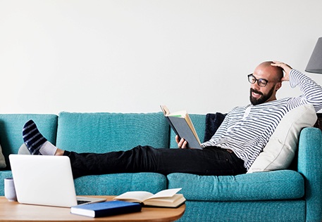 Man reading on couch 