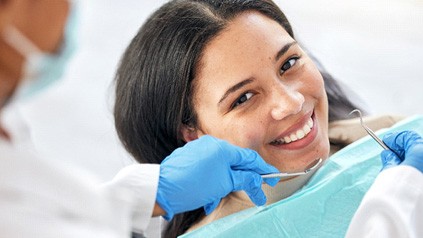 a patient having her teeth examined by a dentist