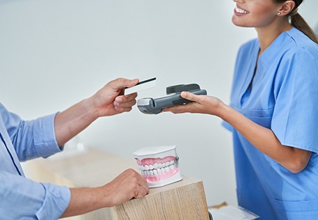 a person paying for dental treatment